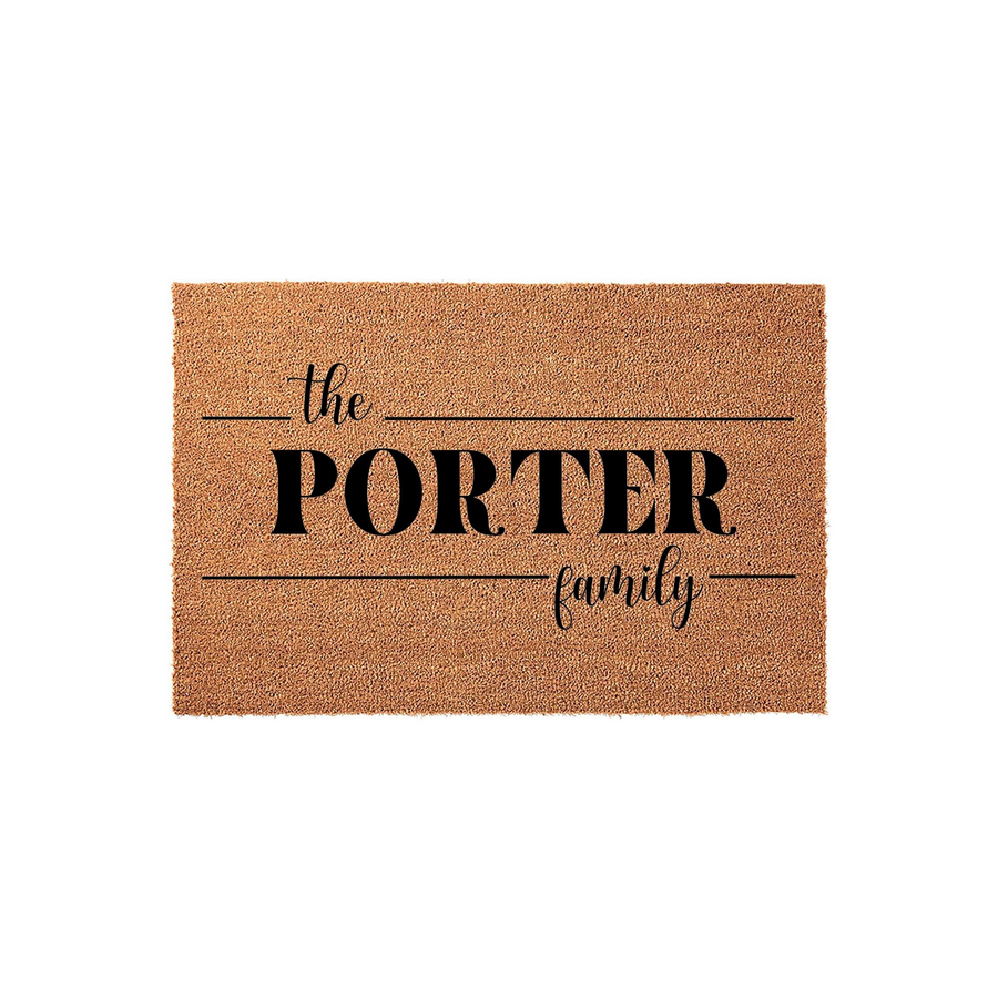 Personalized family name coir doormat featuring a natural tan fiber texture with bold black text that reads The Porter Family, creating a welcoming entrance for any home with its classic and clean typography design on a plain