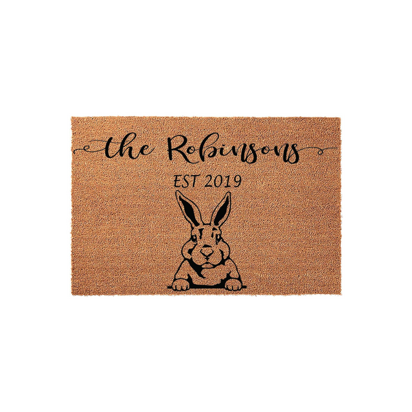 Personalized family name coir doormat featuring a cute black rabbit illustration and custom established date text, set against a plain white background for a clean look that welcomes guests to your home with a charming farmhouse