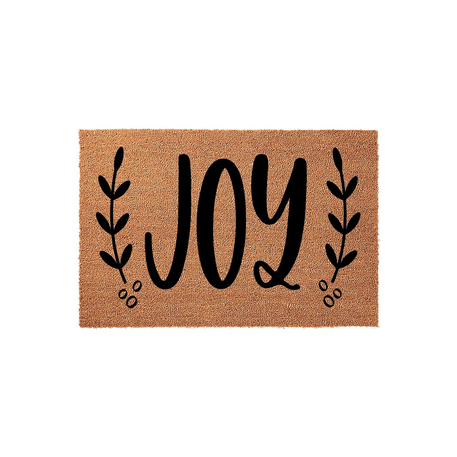 JOY holiday coir doormat featuring a natural brown fiber texture with black script lettering in the center, flanked by elegant leaf sprigs on both sides to create a festive and welcoming entrance for your home during the winter