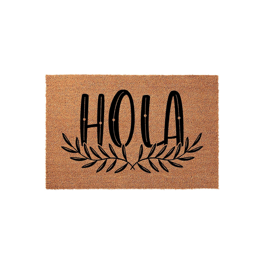 Hola Coir Doormat featuring a natural brown fiber texture with the word Hola printed in bold black lettering above a decorative leafy branch design, creating a welcoming entryway accent for your front porch or home entrance.