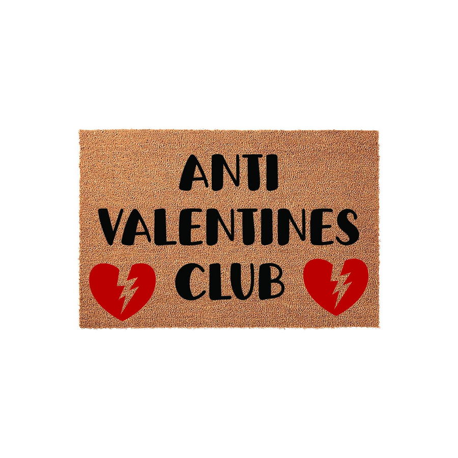 Anti Valentines Club coir doormat featuring bold black text and two red broken heart icons with lightning bolts, set against a natural brown fiber background for a humorous and edgy front porch decor statement piece.