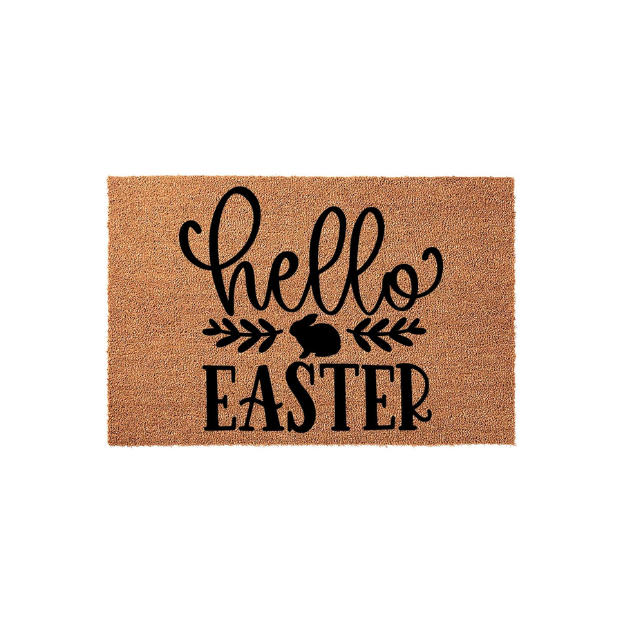 Hello Easter coir doormat featuring a natural brown fiber texture with black printed text and a cute bunny silhouette icon centered between leafy branches, creating a festive spring entryway decor piece for your front porch.
