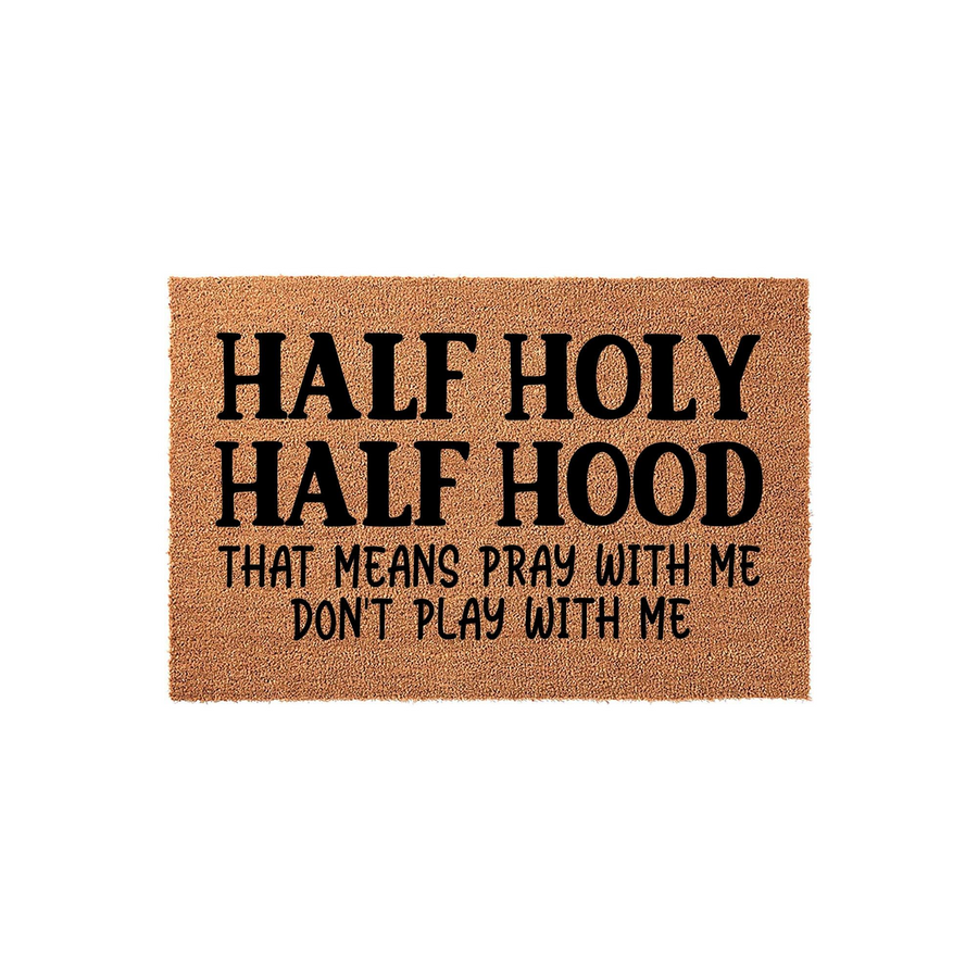 Half Holy Half Hood funny doormat featuring bold black text on a natural coir fiber background, creating a humorous and welcoming entrance piece for your front porch that clearly displays the witty quote for all your house guests