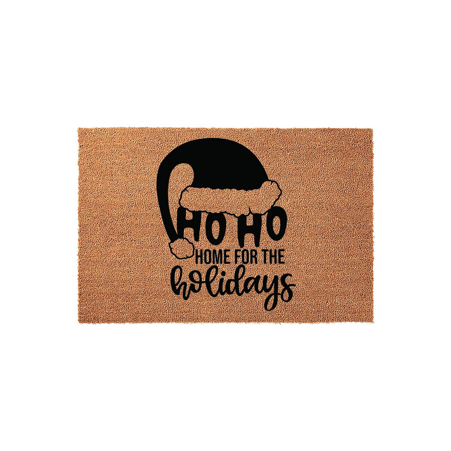 Ho Ho Home for the Holidays Christmas doormat featuring a black Santa hat graphic printed on a natural coir fiber mat, creating a festive entryway decor piece for your front porch during the winter season and holiday celebrations.