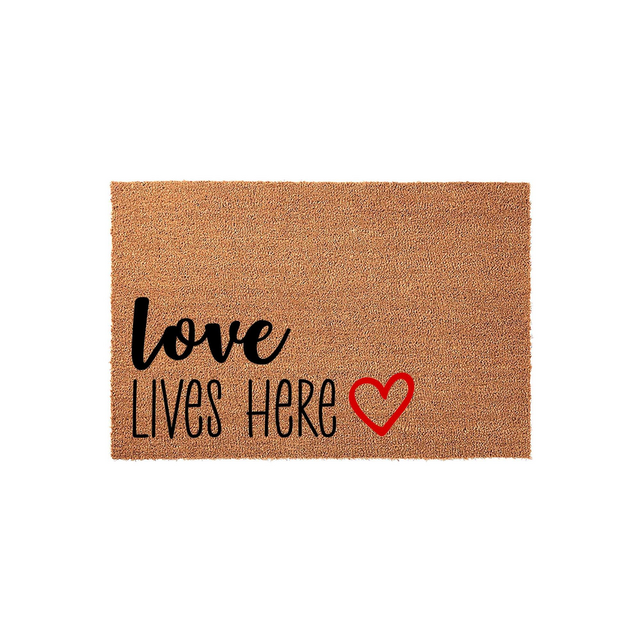 Love Lives Here coir doormat featuring a natural tan fiber texture with black script lettering and a bright red heart icon, providing a warm and inviting welcome for the front porch of any family home on a clean white background.