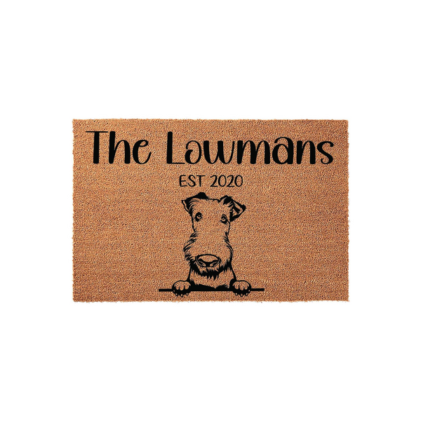 Personalized Airedale Terrier doormat featuring a cute dog illustration peeking over a line, customized with a family name and established year on a natural coir fiber background for a welcoming front porch entrance decor piece.