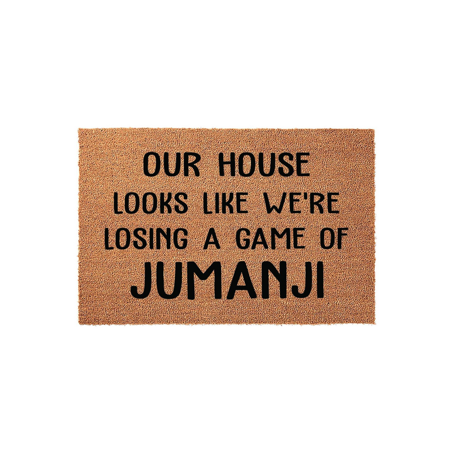 Funny Jumanji quote doormat featuring a natural coir texture and bold black lettering that reads Our House Looks Like We Are Losing A Game Of Jumanji, making it a humorous and welcoming front porch decor piece for any movie fan