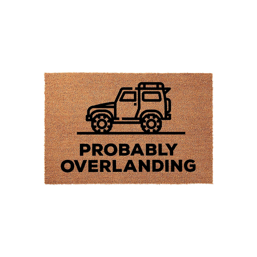 Probably Overlanding doormat featuring a black line art illustration of an off-road adventure vehicle on a natural tan coir background, with the bold text Probably Overlanding printed clearly underneath the rugged 4x4 truck