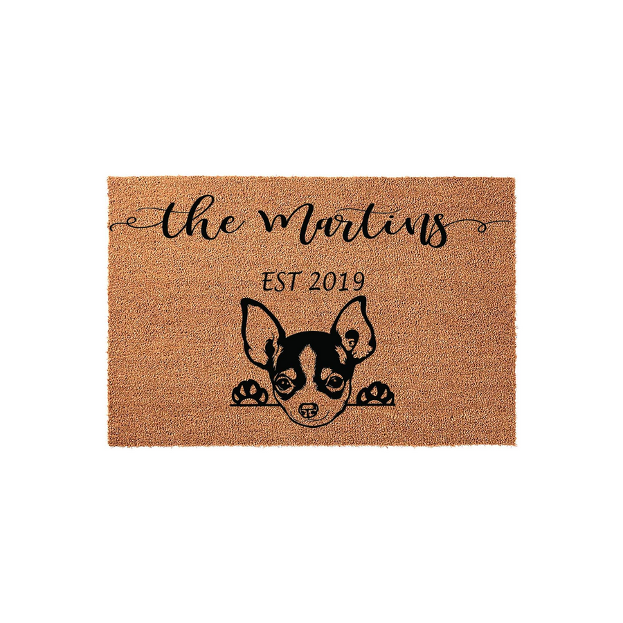 Personalized Chihuahua Coir Doormat featuring a cute dog illustration peeking over the bottom edge, with custom family name text and established year printed in black ink on a natural brown textured fiber background for a home