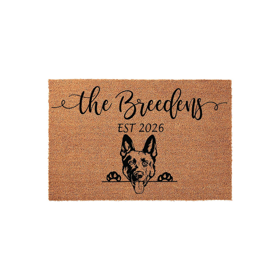 Personalized German Shepherd doormat featuring a natural coir texture with a black printed illustration of a dog peeking over the edge, customized with a family name and established year on a clean white background for a modern