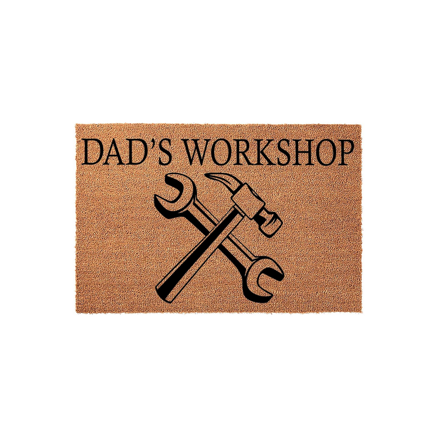 Dad's Workshop coir doormat featuring a rustic brown texture with black printed text and a graphic of a crossed hammer and wrench, making a functional and personalized entrance mat for a garage or home workshop space.