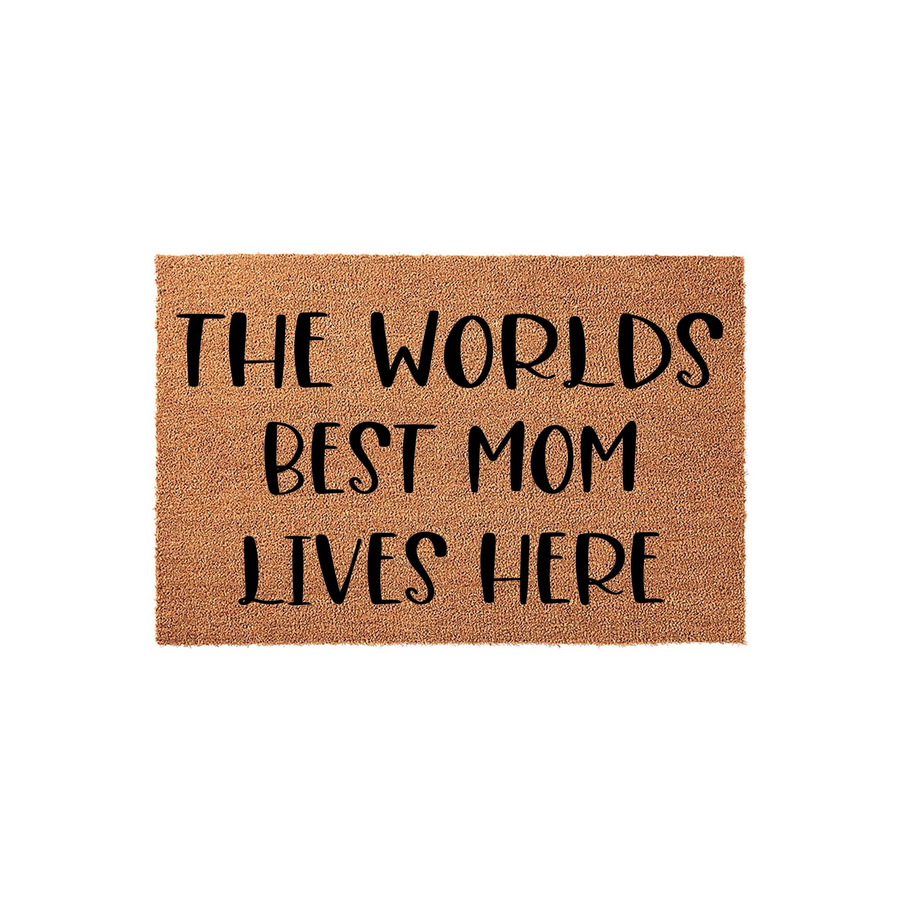 Worlds Best Mom Lives Here coir doormat featuring a natural brown fiber texture and bold black lettering, providing a welcoming and celebratory entrance piece for a home that honors a beloved mother on a clean white studio
