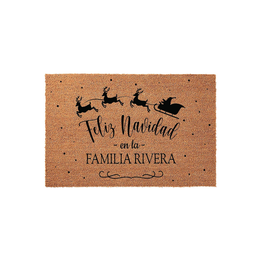 Personalized Feliz Navidad coir doormat featuring a black silhouette of Santa and his reindeer flying across the top, with custom family name text printed in the center against a natural brown textured coconut fiber background.