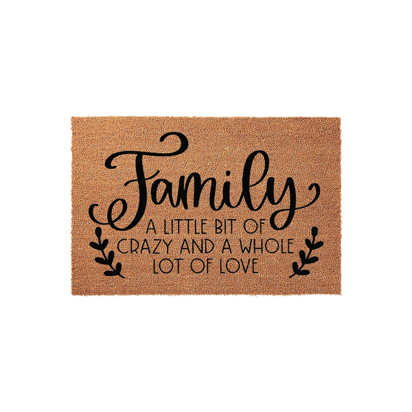 Family coir doormat featuring the text A Little Bit of Crazy and a Whole Lot of Love in black script and sans-serif lettering, set against a natural brown coconut fiber background with decorative leaf accents on a plain white