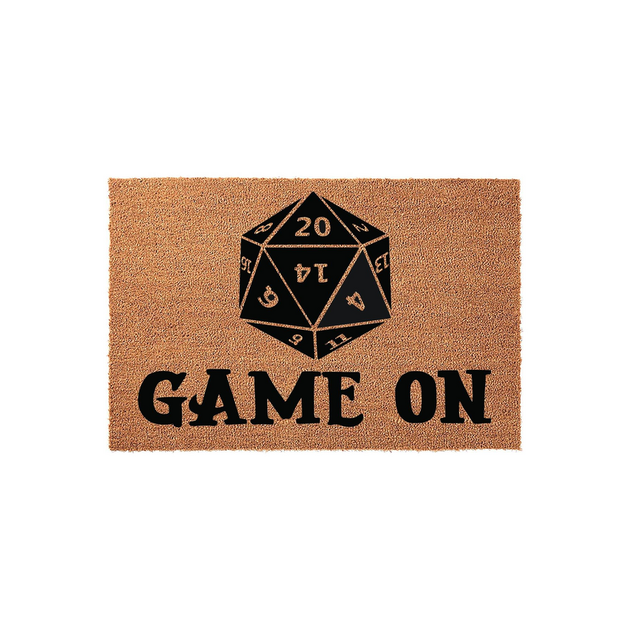 Dungeons and Dragons D20 doormat featuring a large black twenty-sided die graphic centered above the bold text Game On, printed on a natural brown coir fiber mat that is perfect for any gamer home entrance or tabletop gaming room.