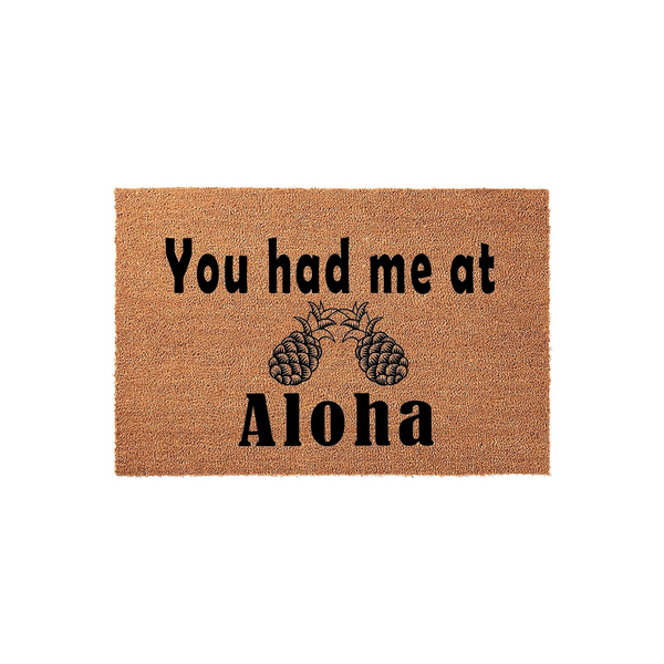Tropical Pineapple Welcome Doormat featuring the phrase You had me at Aloha in bold black lettering, set against a natural tan coir fiber background that adds a fun and inviting coastal aesthetic to any front porch or entryway