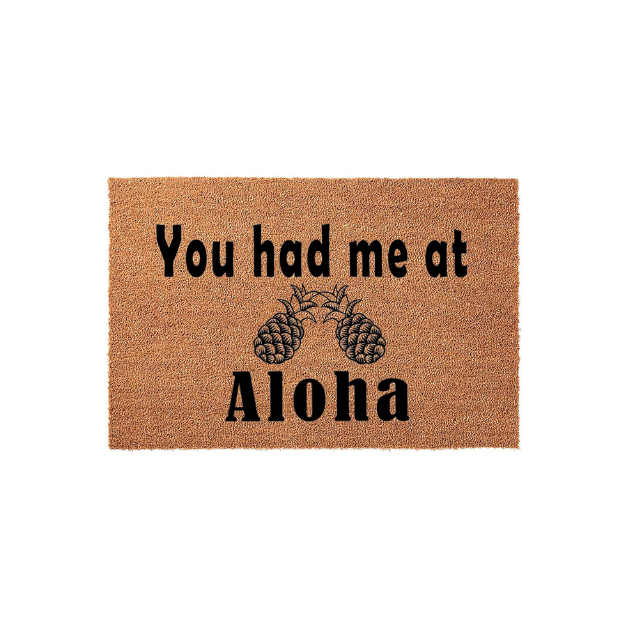 Tropical Pineapple Welcome Doormat featuring the phrase You had me at Aloha in bold black lettering, set against a natural tan coir fiber background that adds a fun and inviting coastal aesthetic to any front porch or entryway