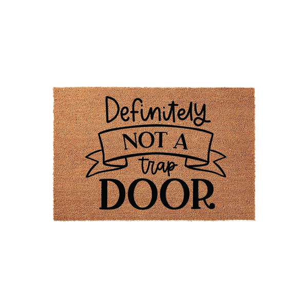 Funny Definitely Not A Trap Door doormat made of natural coir fiber, featuring bold black text and a decorative ribbon graphic centered on a rectangular mat against a clean white background for a humorous home entryway accent.