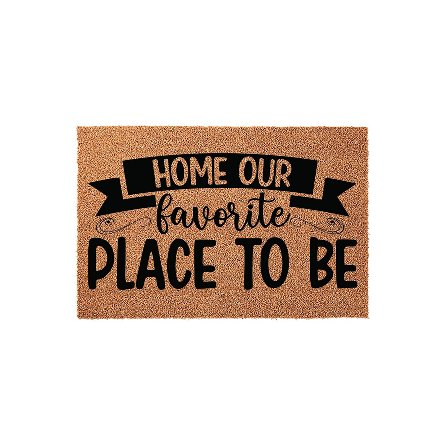 Home Our Favorite Place To Be coir doormat featuring a natural tan fiber texture and bold black typography, designed as a welcoming front porch rug for a cozy home entrance that adds a charming touch to any entryway decor.