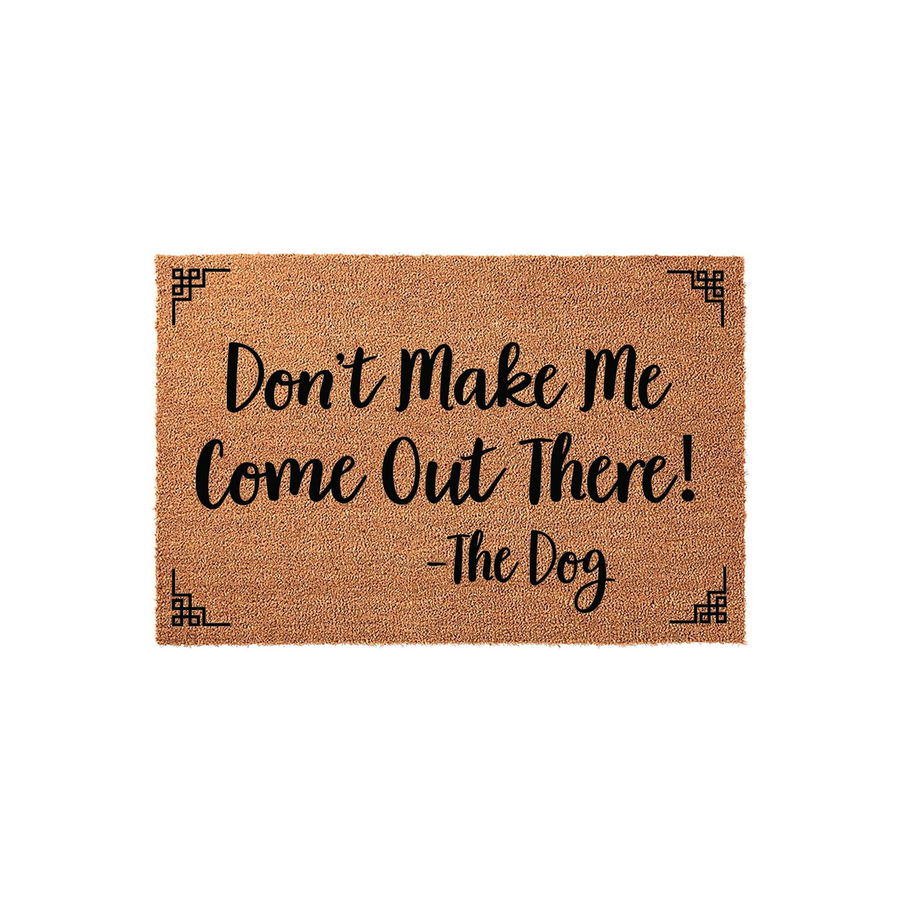 Funny Dog Welcome Doormat featuring a natural coir texture with black text that reads Don't Make Me Come Out There! - The Dog, accented by decorative geometric corner designs on a clean white background for a modern entryway