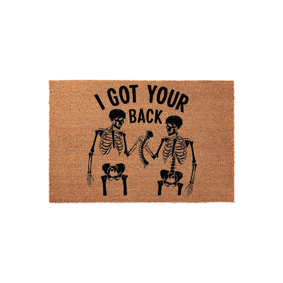 I Got Your Back skeleton doormat featuring two black skeletons fist bumping on a natural coir fiber background, making a humorous and spooky front porch decor piece for Halloween or year-round home entryways with a fun, gothic