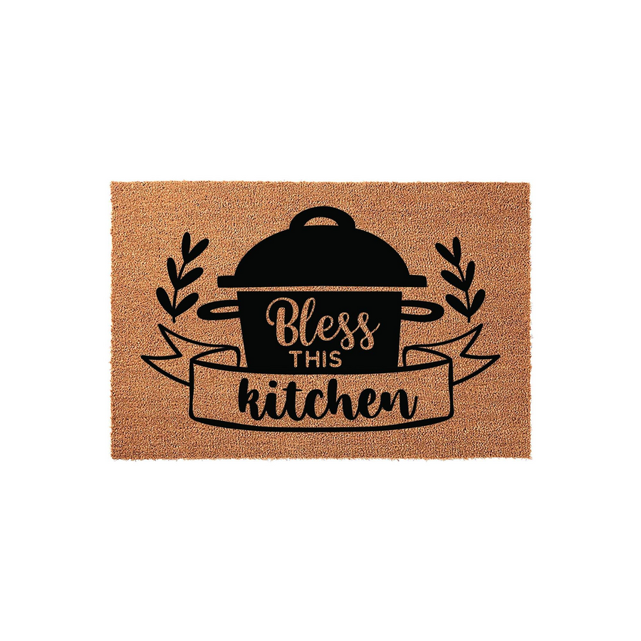 Bless This Kitchen coir doormat featuring a black printed design of a cooking pot with leafy sprigs and a decorative banner, providing a rustic farmhouse aesthetic for your home entryway or kitchen floor decor on a natural fiber
