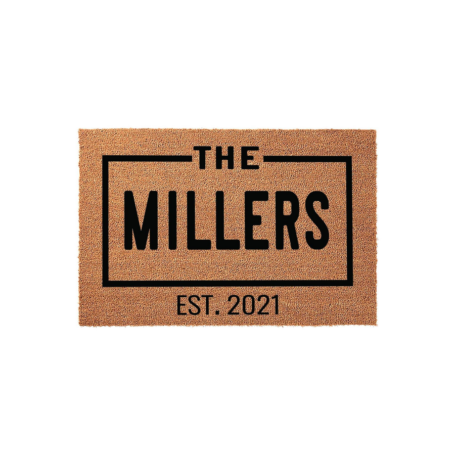 Personalized family name coir doormat featuring a clean, modern black rectangular border design with the text The Millers and an established year, set against a natural tan textured coconut fiber background for a welcoming home