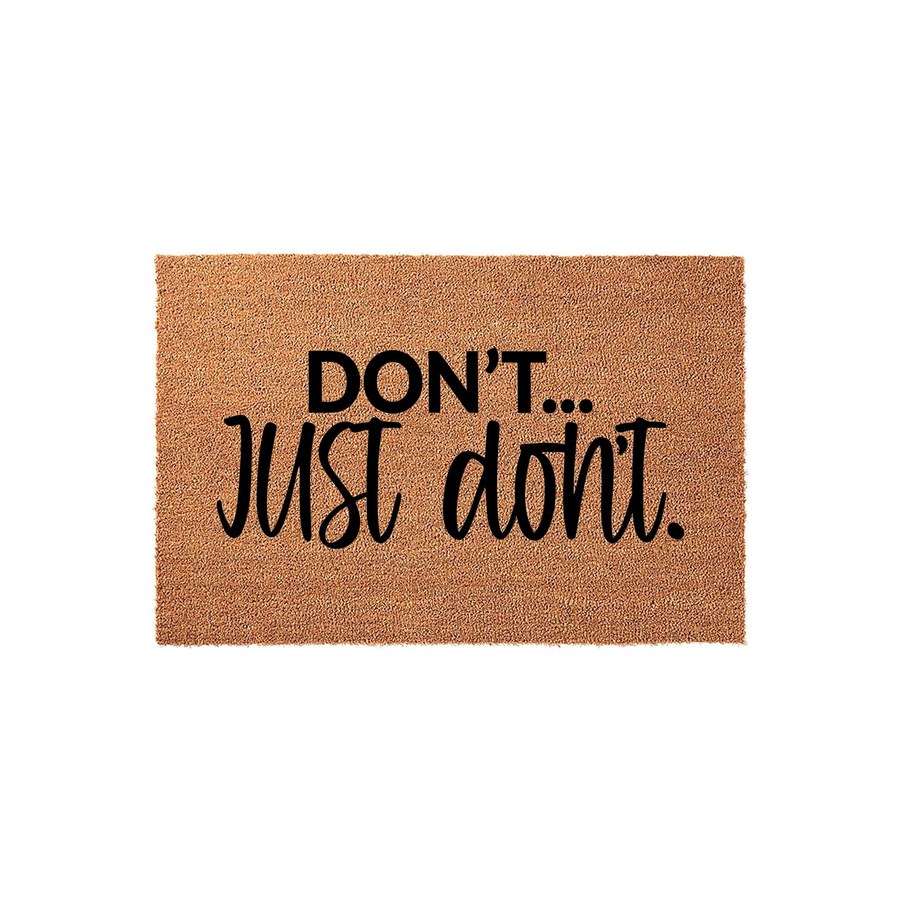Funny Do Not Disturb Doormat featuring the text DON'T... JUST dont. in bold black lettering on a natural brown coir fiber mat, creating a humorous and welcoming entrance for your front porch or home entryway decor on a plain