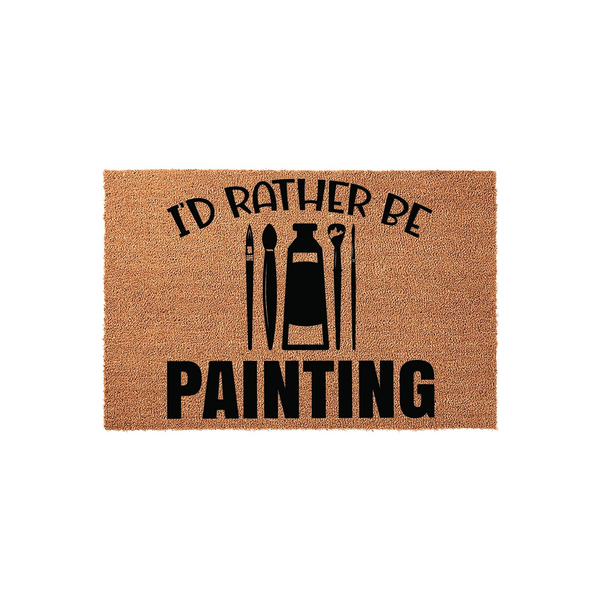 Id Rather Be Painting doormat featuring a natural coir texture with black printed text and artistic icons of paintbrushes and a paint tube, creating a fun entryway decor piece for any artist or creative person who loves to paint.