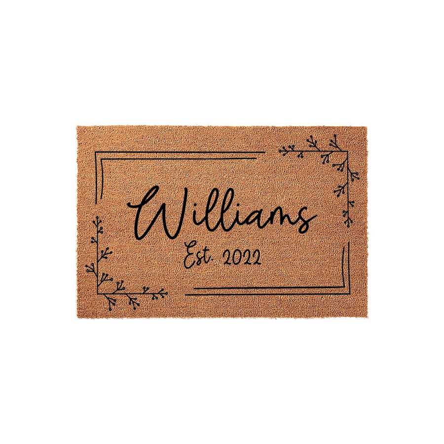 Personalized family name coir doormat featuring a minimalist black line border and delicate botanical corner accents, displaying a custom last name and established year on a natural brown textured fiber background for a modern