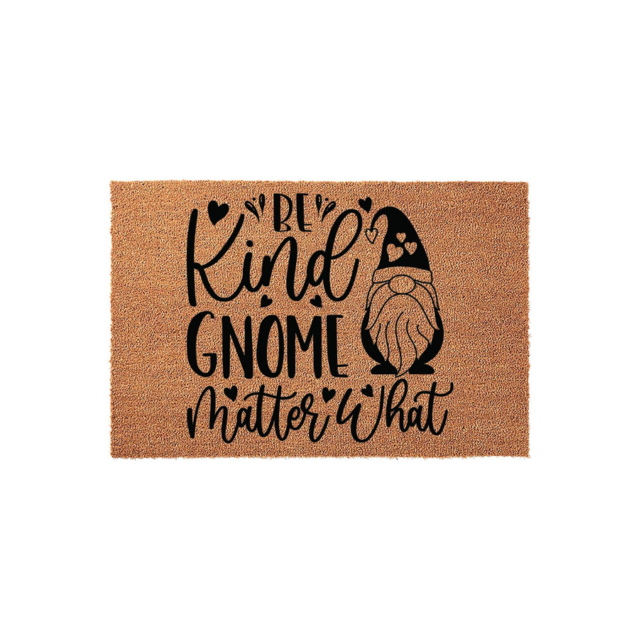 Be Kind Gnome Matter What doormat featuring a cute bearded gnome illustration and black text printed on a natural tan coir fiber background, creating a welcoming and whimsical entryway decor piece for your home or front porch.