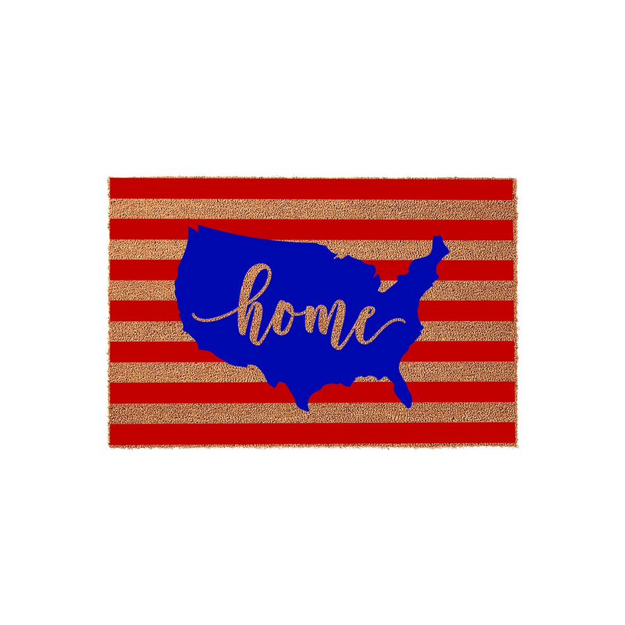 Patriotic USA Map Doormat featuring a red and tan striped coir background with a bold blue silhouette of the United States map in the center, accented by the word home written in a stylish gold cursive script for a festive