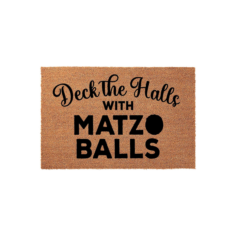 Deck the Halls with Matzo Balls coir doormat featuring a humorous holiday message in black script and bold block lettering, set against a natural tan textured fiber background for a festive and funny seasonal entryway decoration.