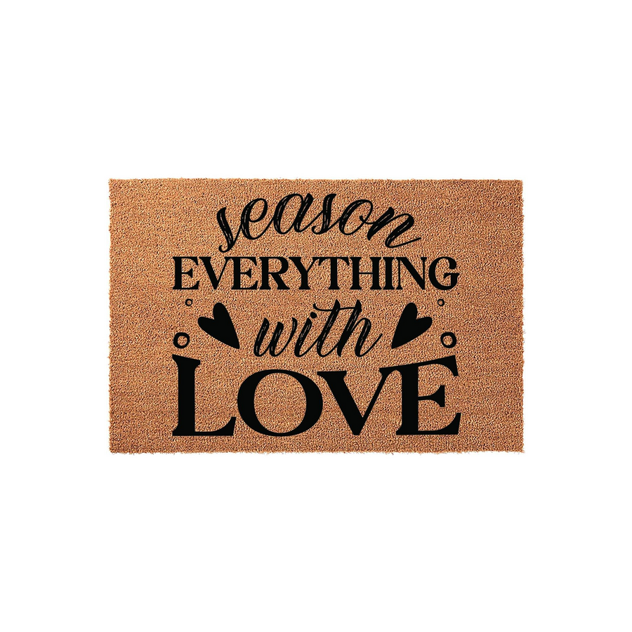 Season Everything With Love coir doormat featuring a natural tan fiber texture and bold black typography, accented with small heart icons to create a warm and inviting entryway decor piece for your home or kitchen floor space.