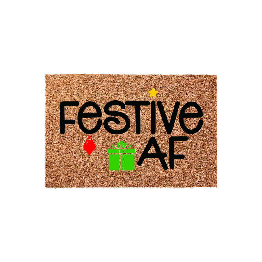 Festive AF Christmas doormat made of natural coir fiber, featuring bold black text accented with a bright green gift box, a red ornament, and a small yellow star against a plain white background for a fun holiday home entryway