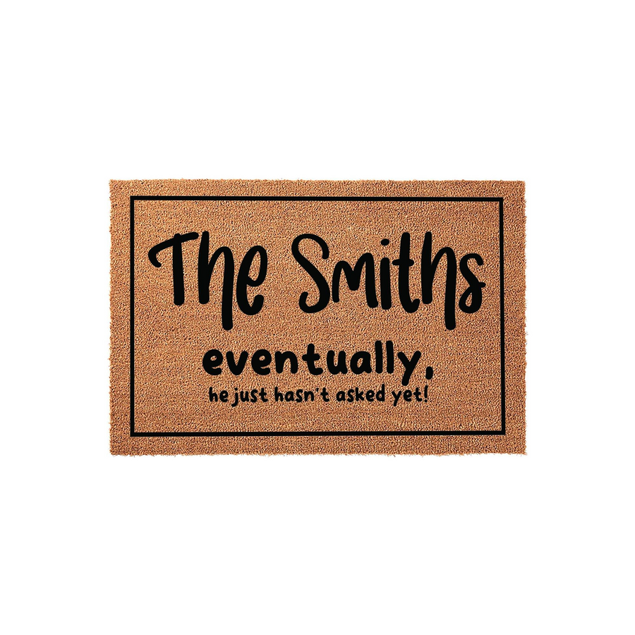 Personalized coir doormat featuring a humorous message about a family name, printed in bold black lettering on a natural tan fiber background with a simple rectangular border, perfect for a front porch or entryway home decor.