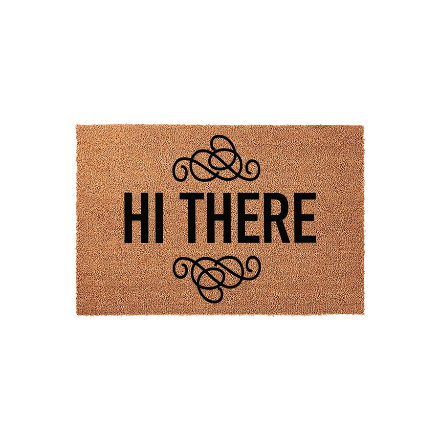 Hi There coir doormat featuring a natural tan fiber texture with bold black text and elegant decorative swirls above and below the greeting, creating a welcoming entrance piece for a front porch or home entryway on a plain