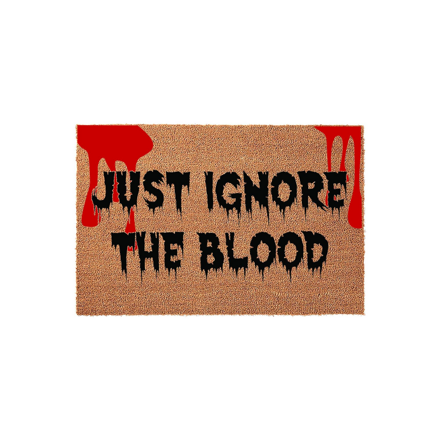 Funny Halloween doormat featuring the text Just Ignore The Blood in a spooky dripping font, set against a natural coir background with bright red blood splatter accents for a scary and festive entryway decor piece for the holiday