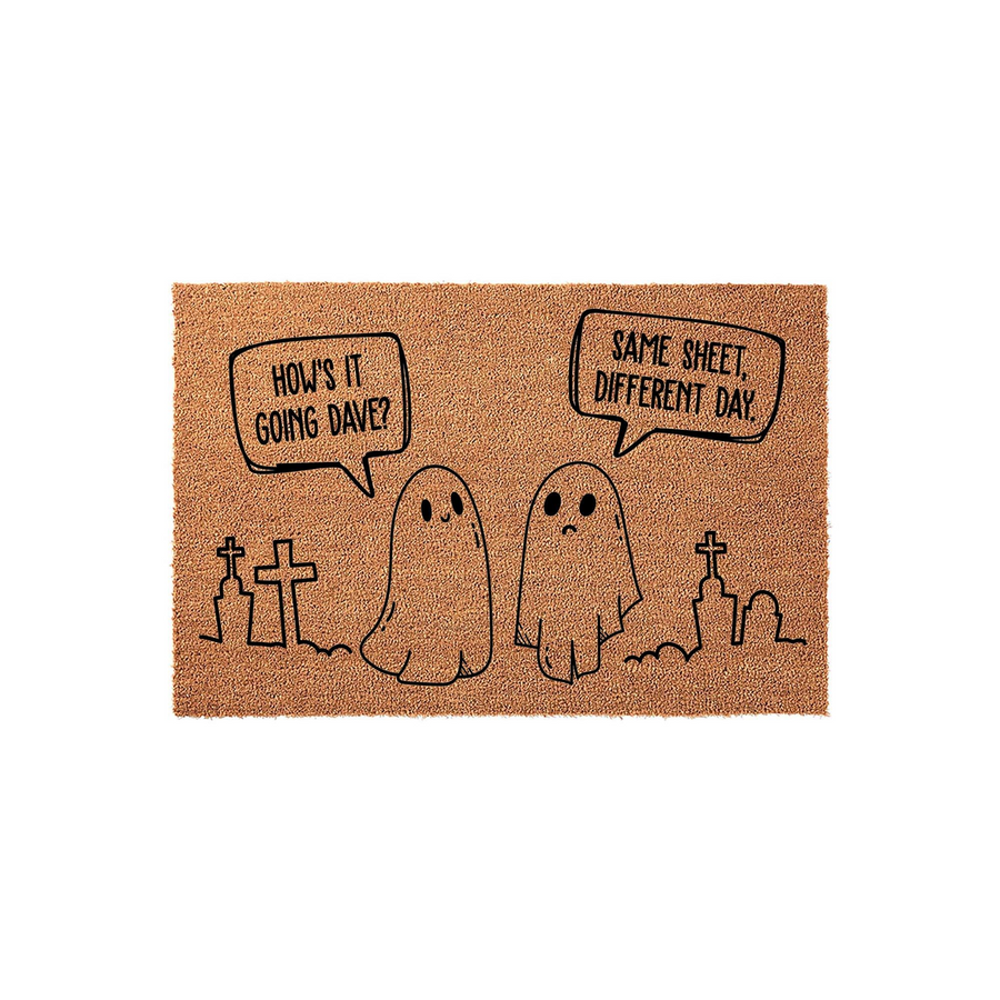 Funny Ghost Halloween Doormat featuring two cute ghosts in a graveyard with speech bubbles that say How is it going Dave and Same sheet different day, printed on a natural brown coir fiber mat for a spooky and humorous entryway