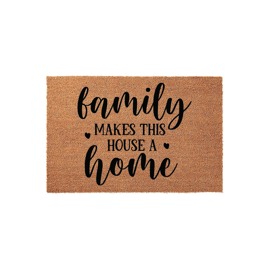 Family Makes This House A Home coir doormat featuring a natural tan fiber texture and bold black script lettering, providing a warm and inviting entrance decor piece for any front porch or entryway to celebrate family life.