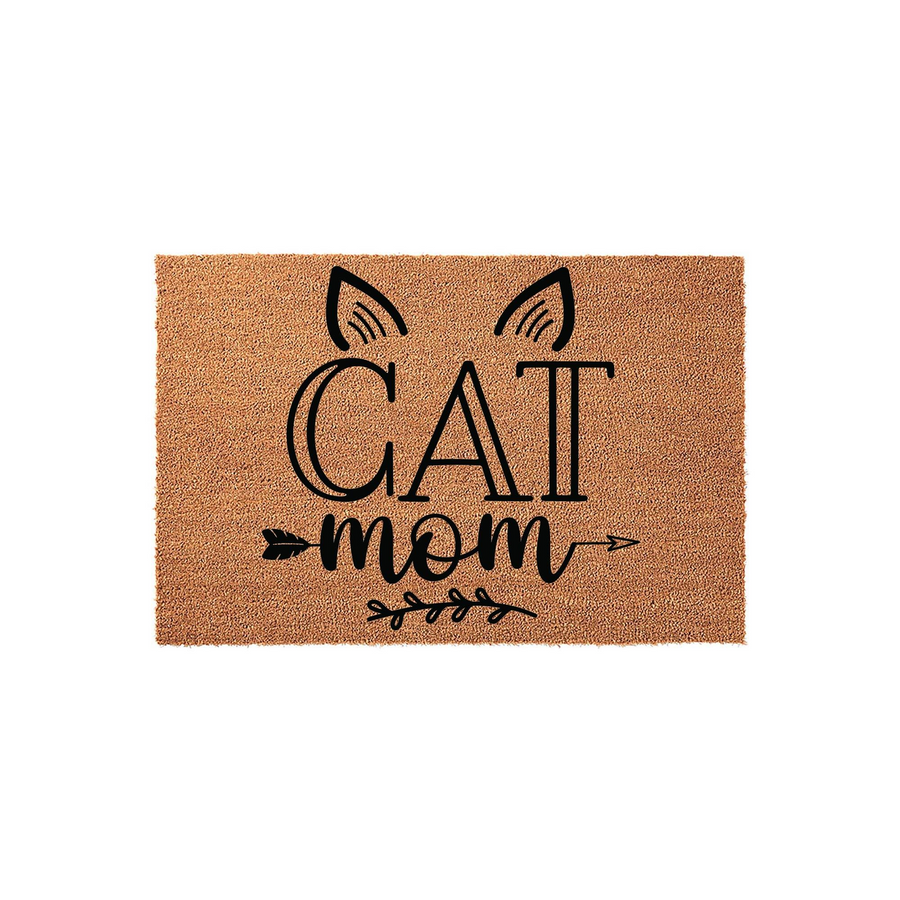 Cat Mom coir doormat featuring a natural brown fiber texture with black printed text that reads Cat Mom, accented by stylized cat ears, an arrow design, and a delicate leafy branch graphic on a clean, solid white studio