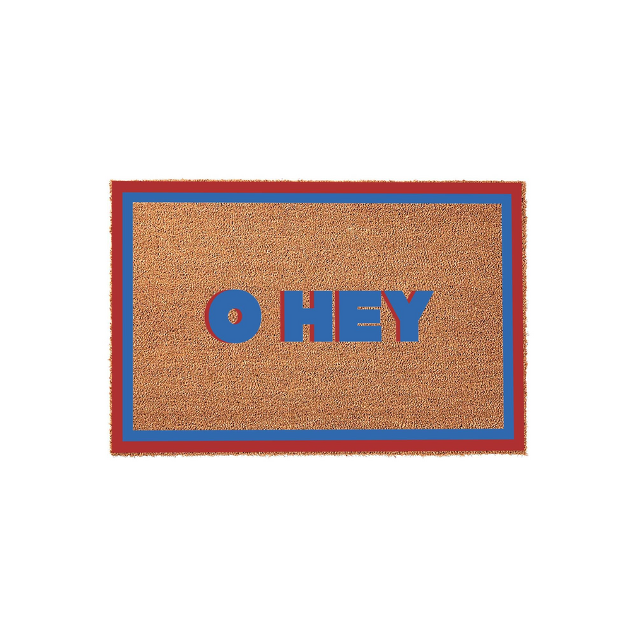 Oh Hey coir doormat featuring a natural brown fiber texture with a bold red and blue border, displaying the playful greeting Oh Hey in matching red and blue block lettering centered on a clean, solid white studio background.