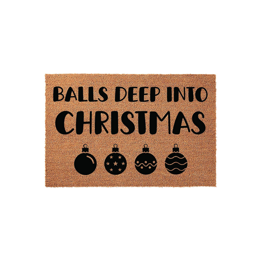 Funny Christmas doormat featuring the text Balls Deep Into Christmas in bold black lettering, accented by four decorative holiday ornament icons on a natural brown coir fiber background for a festive and humorous seasonal