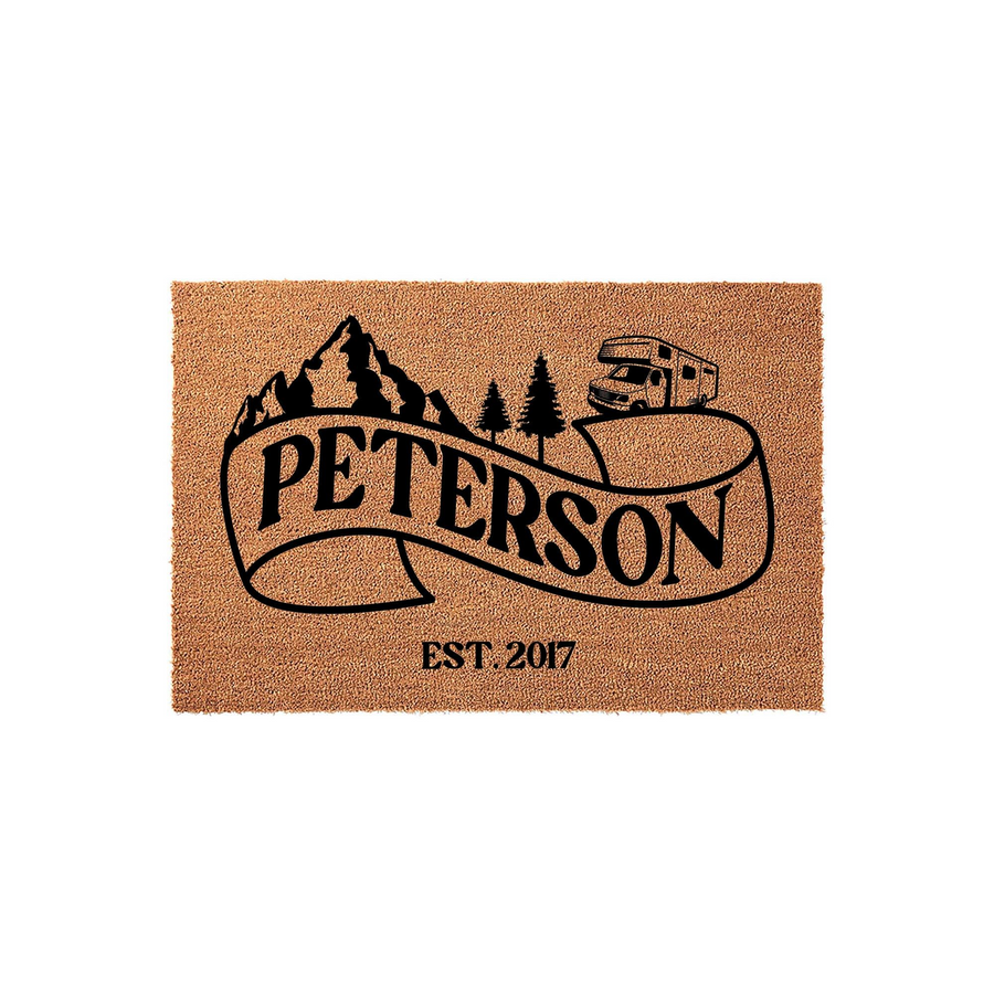 Personalized Camping Doormat featuring a mountain and RV design on a natural coir background, displaying a family name on a ribbon banner with an established year below, perfect for outdoor entryways and RV travel enthusiasts.