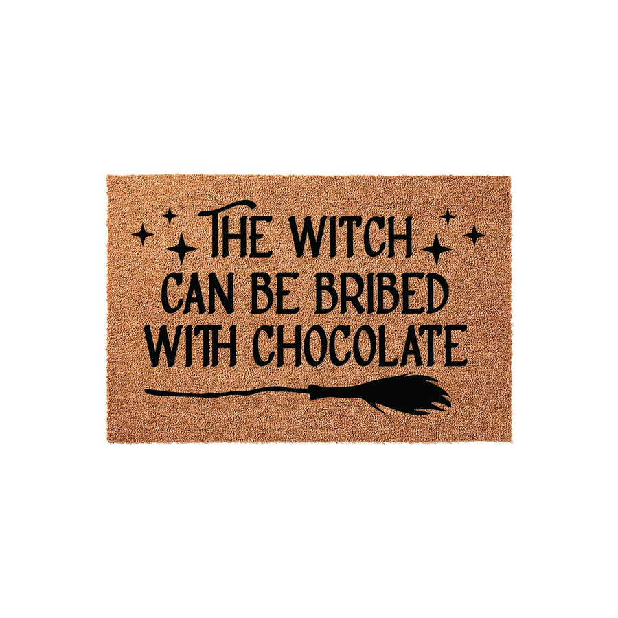 Funny Witch Halloween Doormat featuring the text The Witch Can Be Bribed With Chocolate in black lettering, accented by decorative stars and a broomstick illustration on a natural coir fiber background for a festive front porch