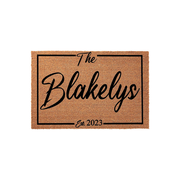 Personalized family name coir doormat featuring a classic rectangular border design with the text The Blakelys and Est. 2023 printed in elegant black script, providing a welcoming and durable entrance mat for any home front porch.