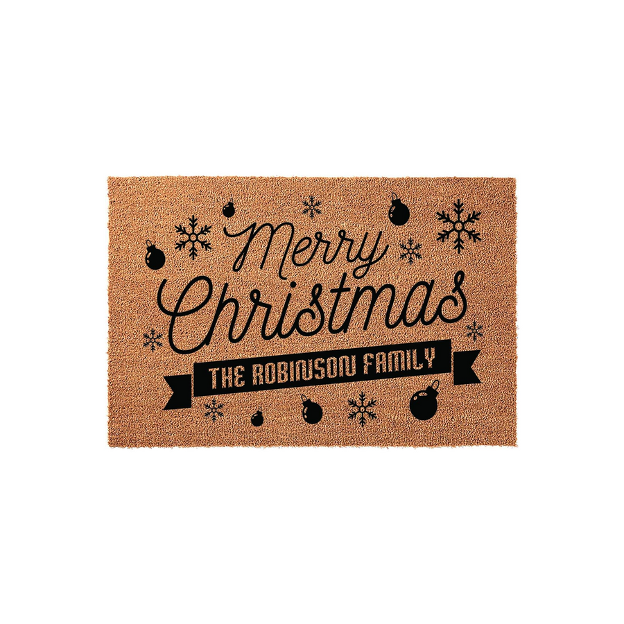 Personalized Merry Christmas coir doormat featuring a festive holiday design with black snowflakes and ornaments, displaying a custom family name on a banner against a natural tan fiber background for a welcoming seasonal