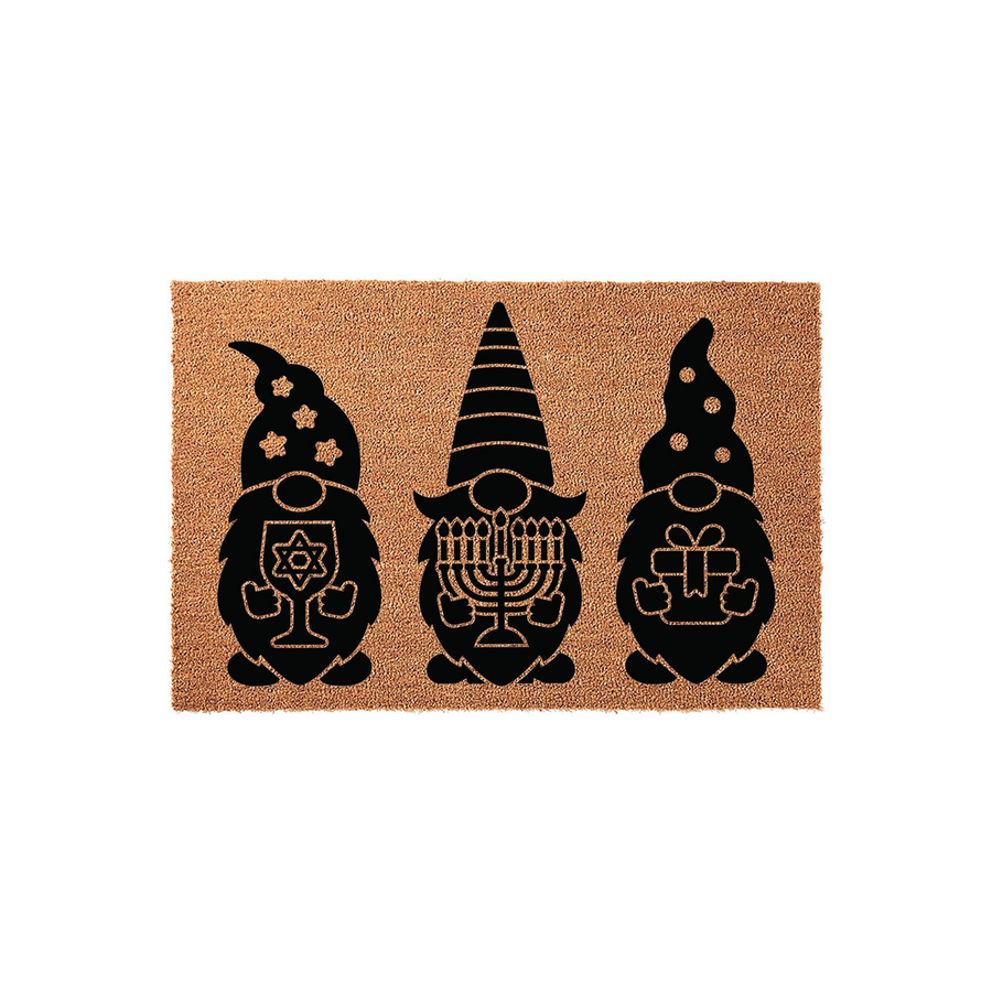 Hanukkah Gnome Coir Doormat featuring three black gnome silhouettes printed on a natural brown fiber background, with each gnome holding a different holiday icon including a Star of David, a menorah, and a wrapped gift for