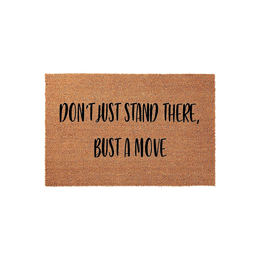 Funny Doormat with Don't Just Stand There, Bust A Move text printed in black on a natural brown coir fiber mat, featuring a rectangular shape and a textured surface that is ideal for a front porch or entryway home decor accent