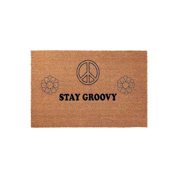 Stay Groovy coir doormat featuring a retro 70s aesthetic with a black peace sign and two daisy flower icons printed on a natural brown fiber background, creating a fun and welcoming entrance for your home or front porch decor.